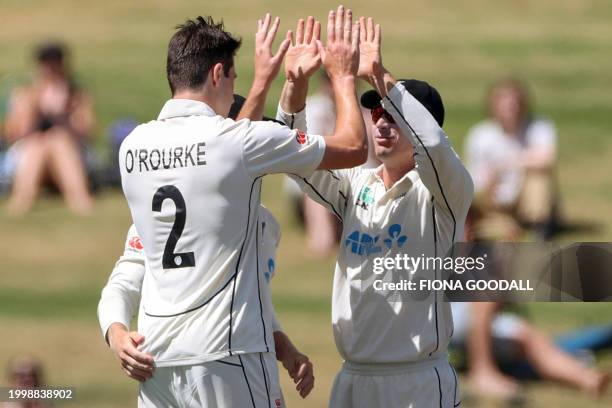 New Zealand's Will Young congratulates teammate Will O'Rourke for taking his first Test wicket on day one of the second Test cricket match between...