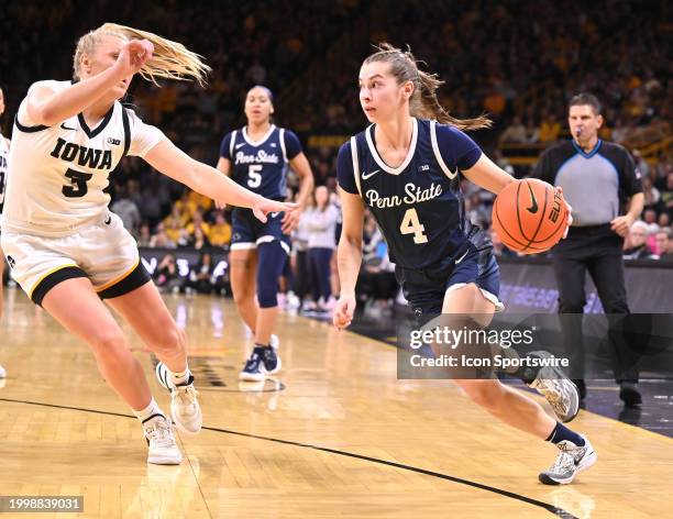 Penn State guard Shay Ciezki drives to the basket as Iowa guard Sydney Affolter defends during a women's college basketball game between the Penn...