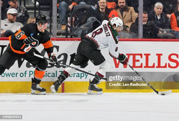 Nick Schmaltz of the Arizona Coyotes controls the puck along the boards while being pursued by Travis Sanheim of the Philadelphia Flyers at the Wells...