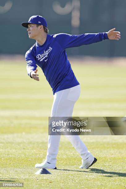 Yoshinobu Yamamoto warms up at spring training with the Los Angeles Dodgers in Glendale, Arizona, on Feb. 12, 2024.