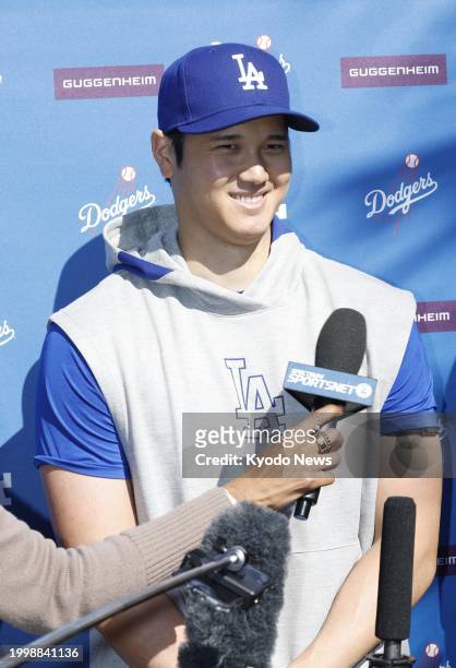 Shohei Ohtani meets the press after taking batting practice at spring training with the Los Angeles Dodgers in Glendale, Arizona, on Feb. 12, 2024.