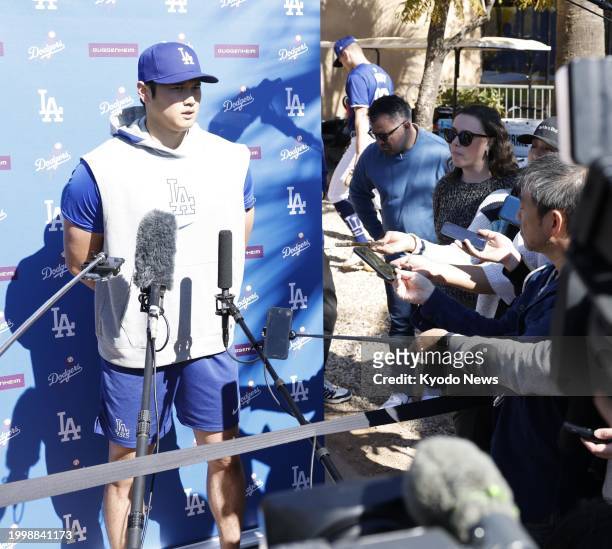 Shohei Ohtani meets the press after taking batting practice at spring training with the Los Angeles Dodgers in Glendale, Arizona, on Feb. 12, 2024.