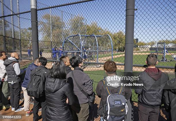 Journalists watch Shohei Ohtani taking his first outdoor batting practice since elbow surgery, at spring training with the Los Angeles Dodgers in...