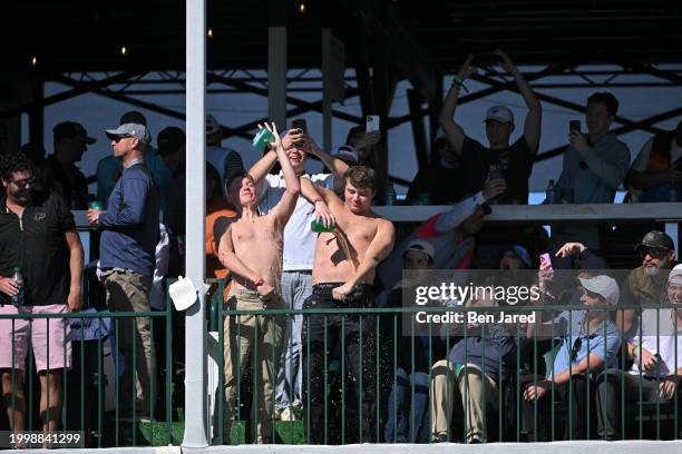 Fans pour beer on themselves on the 16th hole during the final round of WM Phoenix Open at TPC Scottsdale on February 11, 2024 in Scottsdale, Arizona.