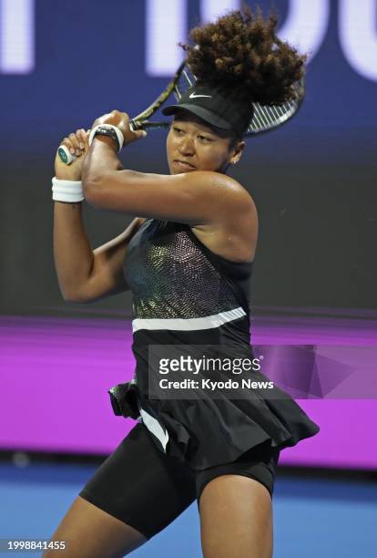 Japan's Naomi Osaka plays against Caroline Garcia of France in the women's singles first round of the Qatar Open tennis tournament in Doha, Qatar, on...