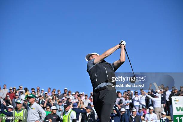 Jordan Spieth hits a tee shot on the 11th hole during the final round of WM Phoenix Open at TPC Scottsdale on February 11, 2024 in Scottsdale,...