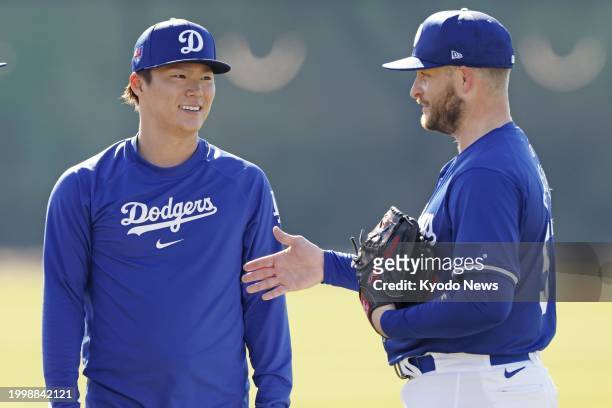 Yoshinobu Yamamoto chats with Ryan Brasier at spring training with the Los Angeles Dodgers in Glendale, Arizona, on Feb. 12, 2024.