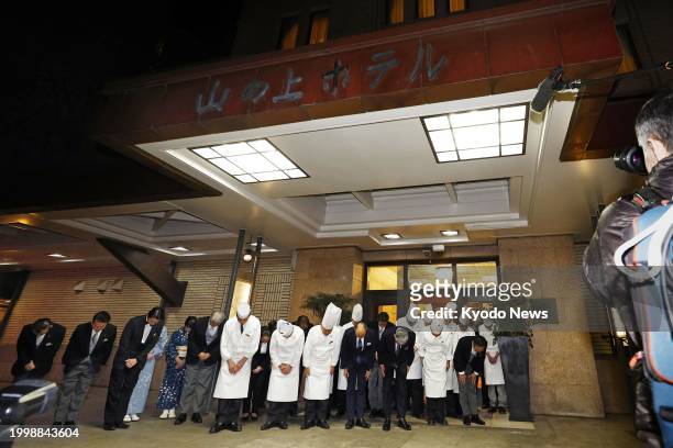 Employees line up in front of the Hilltop Hotel in Tokyo on Feb. 12 as it closes the same day for an undetermined period due to the run-down...
