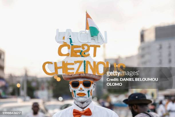 Fan sports a hat celebrating Ivory Coast's victory at the Africa Cup of Nations 2024, during the parade in Abidjan, on February 12, 2024.