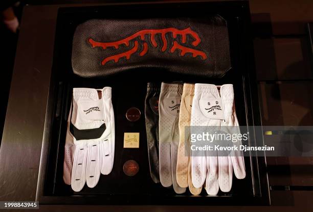 Detail of gloves, ball markers and head covers during the launch of Tiger Woods and TaylorMade Golf's new apparel and footwear brand "Sun Day Red" at...