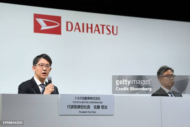 Koji Sato, president of Toyota Motor Corp., left, speaks next to Masahiro Inoue, incoming chief executive officer of Daihatsu Motor Co., during a...