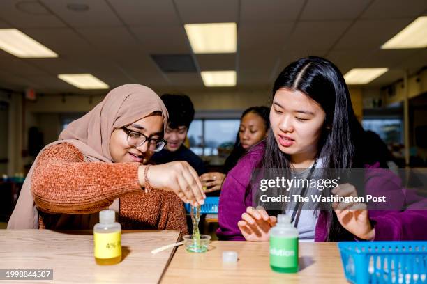 January 31: Tawhida Chowdhury left, and Emily Kim both juniors, look at the non-Newtonian fluid they created at Warren Mott High School in Warren,...