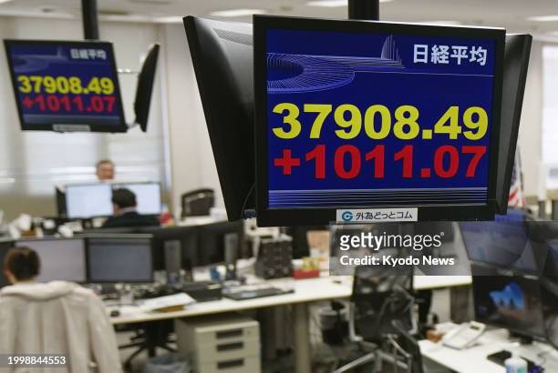 Stock monitor at a financial company in Tokyo shows the 225-issue Nikkei Stock Average rising more than 1,000 points from the previous day's close on...