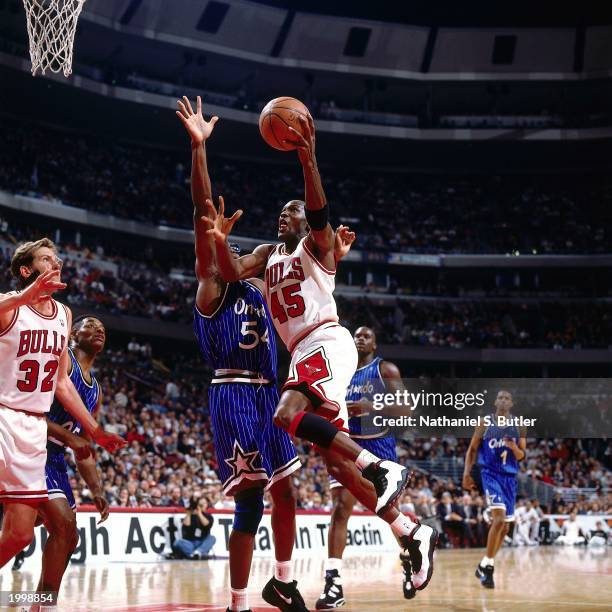 Michael Jordan of the Chicago Bulls attempts a layup against Horace Grant of the Orlando Magic during the NBA game at the United Center on March 24,...