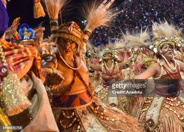 People wearing costumes perform as thousands of people watch the event during the second day of the Samba Schools Parade within the Rio Carnival at...
