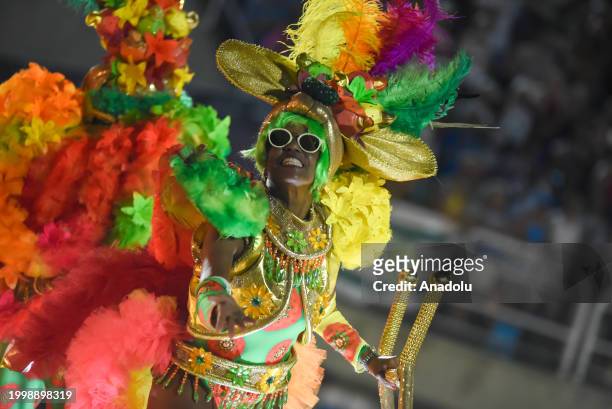 People, wearing costumes, perform as thousands of people watch the event during the second day of the Samba Schools Parade within the Rio Carnival at...