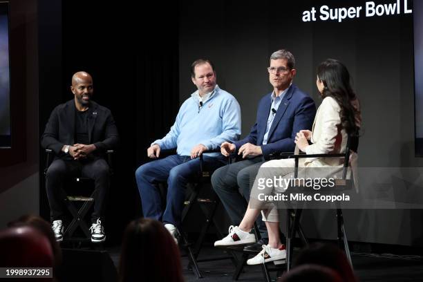 Gary Brantley, Kyle Malady, Jim Harbaugh, and Mina Kimes speak onstage during Verizon’s press conference at Verizon Live at Super Bowl LVIII on...