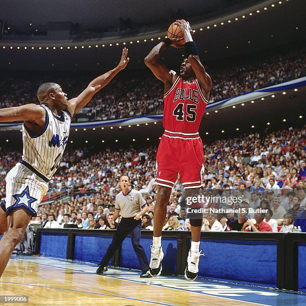 Michael Jordan of the Chicago Bulls takes a jump shot against Nick Anderson of the Orlando Magic in Game one of the Eastern Conference Semifinals...