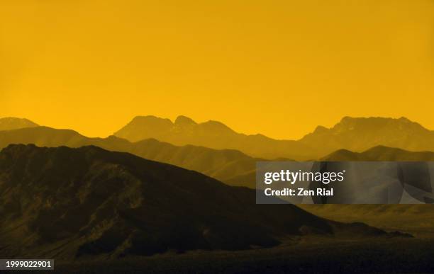 silhouettes of mountain ranges with colors converted to yellow and black - black mountain (nevada) stock pictures, royalty-free photos & images