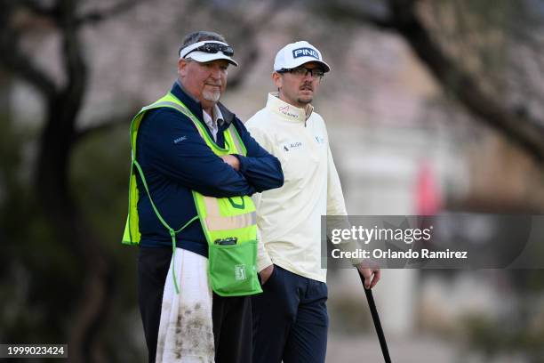 Jim Knous of the United States and his caddie stand on the third green during the second round of the WM Phoenix Open at TPC Scottsdale on February...