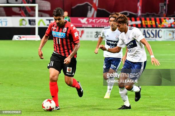 Jonathan Reis of Consadole Sapporo controls the ball against Ken Matsubara of Yokohama F.Marinos during the J.League J1 match between Hokkaido...