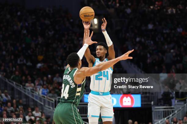 Brandon Miller of the Charlotte Hornets shoots over Giannis Antetokounmpo of the Milwaukee Bucks during the first half of a game at Fiserv Forum on...