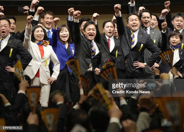 Yuichiro Tamaki , head of the opposition Democratic Party for the People, and other participants raise their fists at a party convention in Tokyo on...