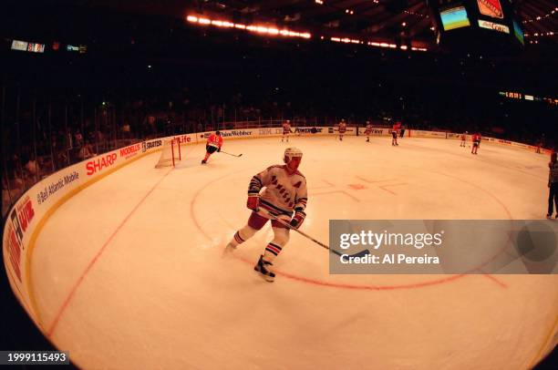 Left Wing Adam Graves of the New York Rangers handles the puck in the game between the Chicago Black Hawks vs the New York Rangers at Madison Square...