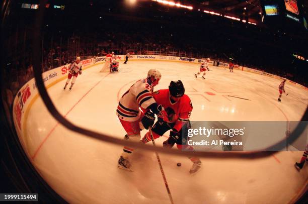 Photographer's Position view of Left Wing Alexi Kovalev of the New York Rangers battling Left Wing Jean-Yves Leroux of the Chicago Blackhawks in the...