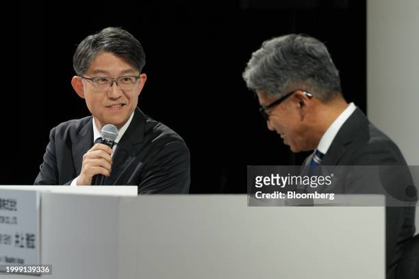 Koji Sato, president of Toyota Motor Corp., left, speaks next to Masahiro Inoue, incoming chief executive officer of Daihatsu Motor Co., during a...