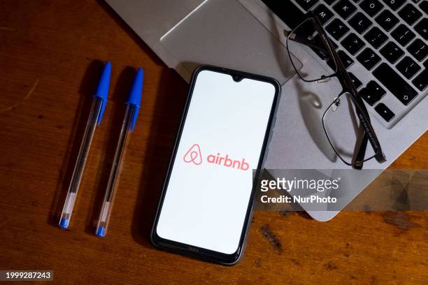 The Airbnb logo is being displayed on a smartphone screen in Athens, Greece, on February 13, 2024.