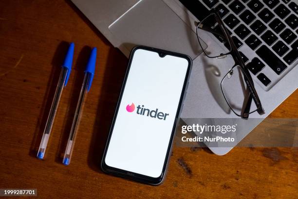 The Tinder logo is being displayed on a smartphone screen in Athens, Greece, on February 13, 2024.