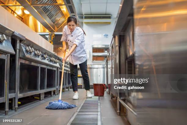 restaurant employee cleaning floor in kitchen - kitchen mop stock pictures, royalty-free photos & images