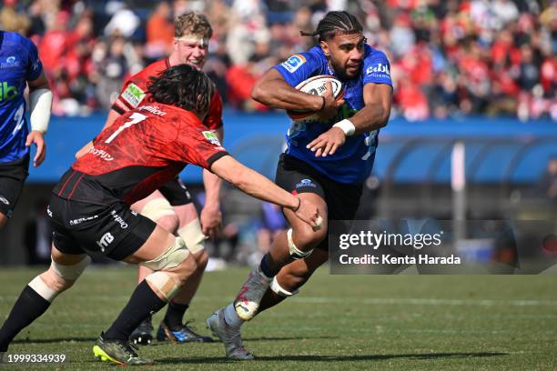 Hoskins Sotutu of Blues is tackled by Naoto Shimada of Yokohama Canon Eagles during the preseason match between Yokohama Canon Eagles and Blues at...