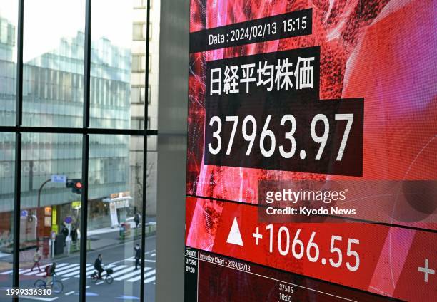 Financial data screen in Tokyo on Feb. 13 shows the 225-issue Nikkei Stock Average finishing at 37,963.97, its highest close since January 1990.