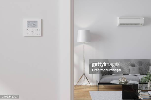 air conditioner control panel on blank wall in living room - air conditioner interior wall stock pictures, royalty-free photos & images