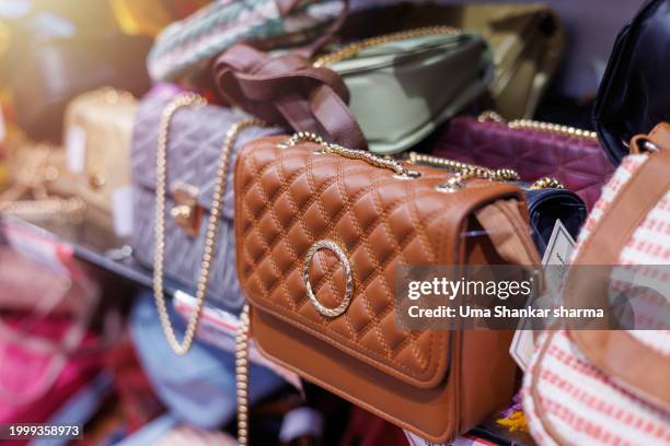brand new designer handbags on shelves of a fashion store for sale. - vintage handbag stock pictures, royalty-free photos & images