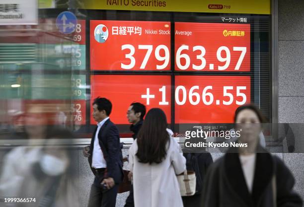 Roadside financial data screen in Tokyo on Feb. 13 shows the 225-issue Nikkei Stock Average finishing at 37,963.97, its highest close since January...