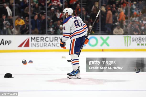 Evander Kane of the Edmonton Oilers looks on as fans throw hats on the ice after he scored an empty net goal, his third goal of the game during the...