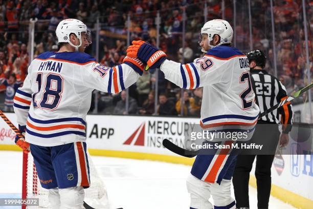 Leon Draisaitl congratulates Zach Hyman of the Edmonton Oilers after his goal during the third period of a game against the Anaheim Ducks at Honda...