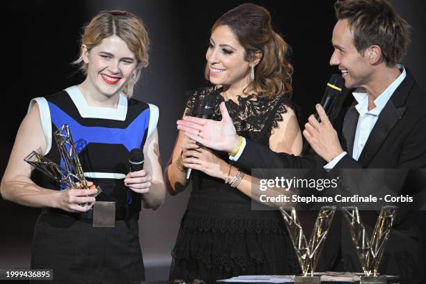 Zaho de Sagazan celebrates as she receives the Best Original Song award next to Masters of Ceremony French TV hosts Lea Salame and Cyril Feraud...