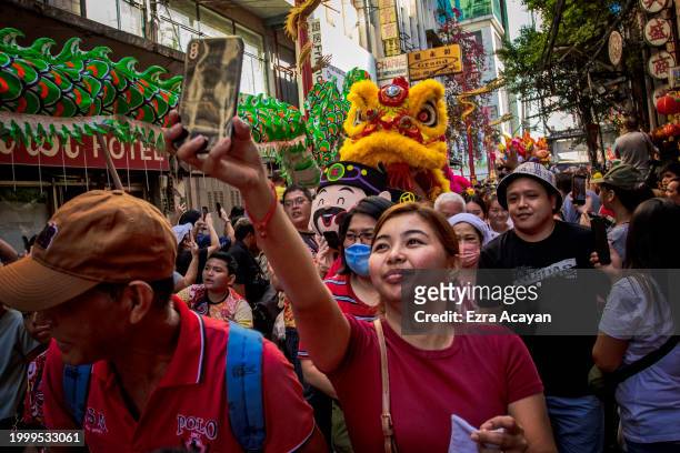 Filipinos watch dragon dancers perform during Lunar New Year celebrations at Binondo district, considered the world's oldest Chinatown, on February...