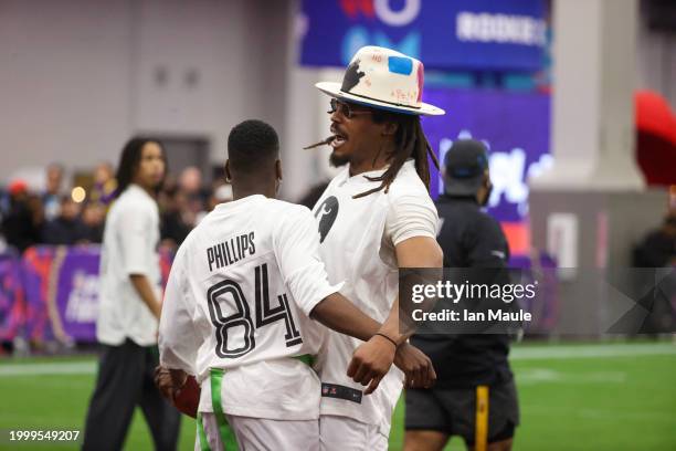 Former NFL quarterback Cam Newton celebrates with Mark Phillips after a touchdown during a celebrity flag football game at the Mandalay Bay...