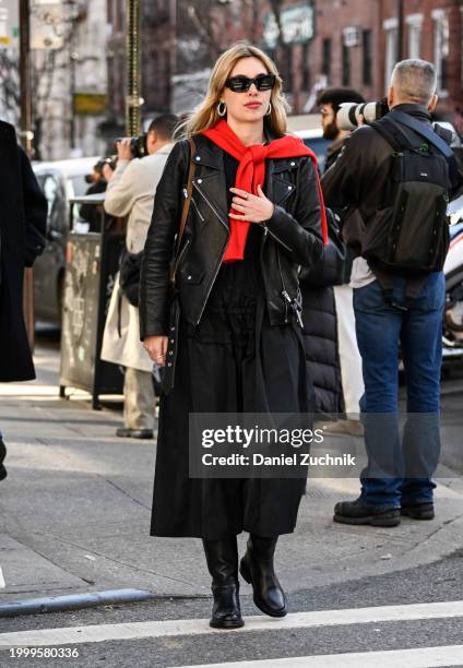 Aemilia Fay is seen wearing a black leather jacket, black top, black pants and black sunglasses outside the Helmut Lang show during NYFW F/W 2024 on...