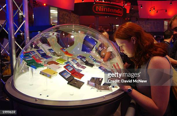 Ginger Cooley of Louisiana looks over Gameboy devices in the Nintendo exhibit area at Interactive Digital Software Association's E3 Expo 2003 gaming...