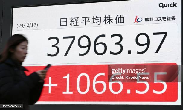 Financial data screen in Tokyo on Feb. 13 shows the 225-issue Nikkei Stock Average finishing at 37,963.97, its highest close since January 1990.