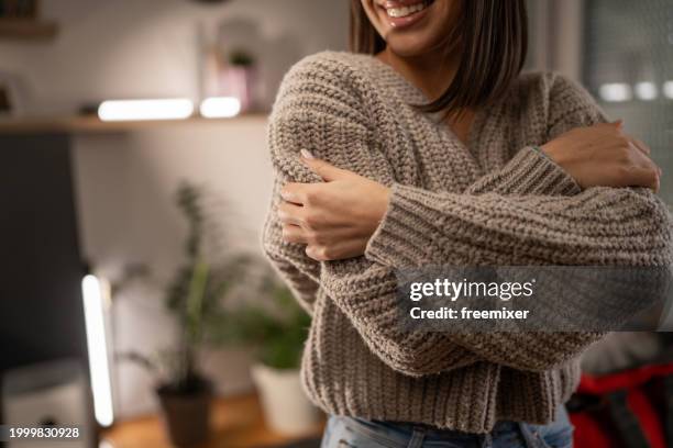 enjoying a new sweater - jumper stock pictures, royalty-free photos & images