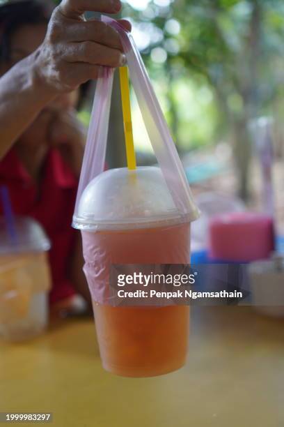 palm juice, palm sap ice in clear plastic cup - woman looking through ice stock pictures, royalty-free photos & images