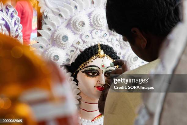 An artisan gives a final touch on an idol of Goddess Saraswati ahead of Vasant Panchami on the 14th of February 2024.