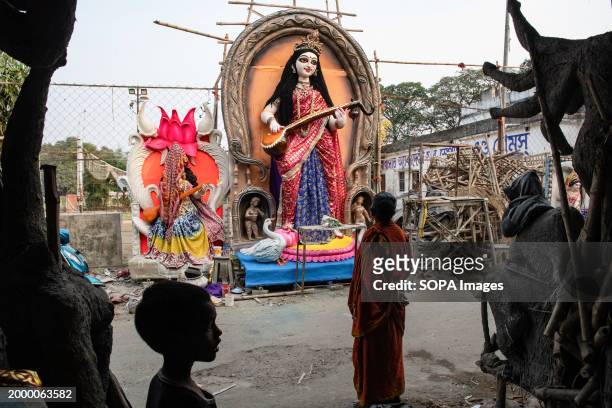 People look at the idols of Goddess Saraswati in a workshop ahead of the Vasant Panchami which is on the 14th of February 2024.